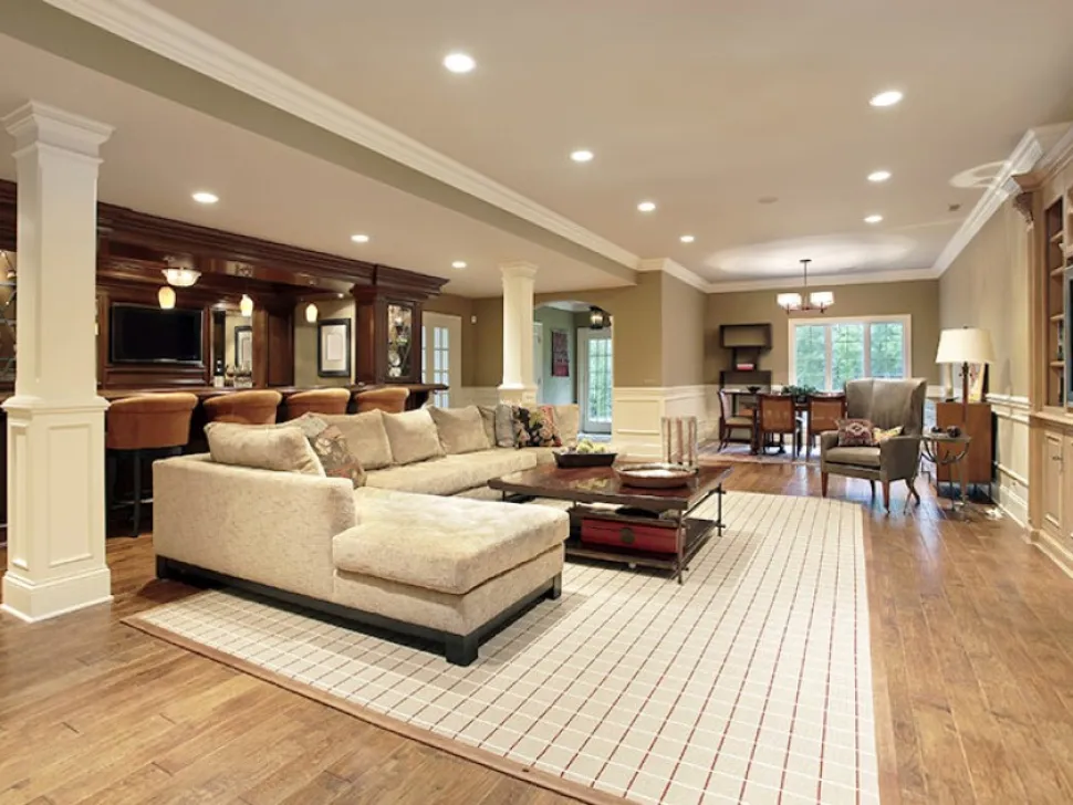 Open-plan living room lit by ceiling downlights