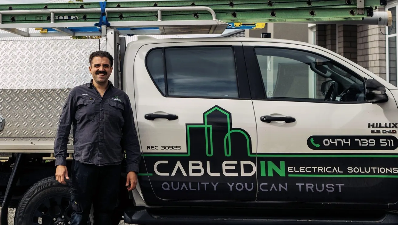 Electrician standing beside a CabledIN ute