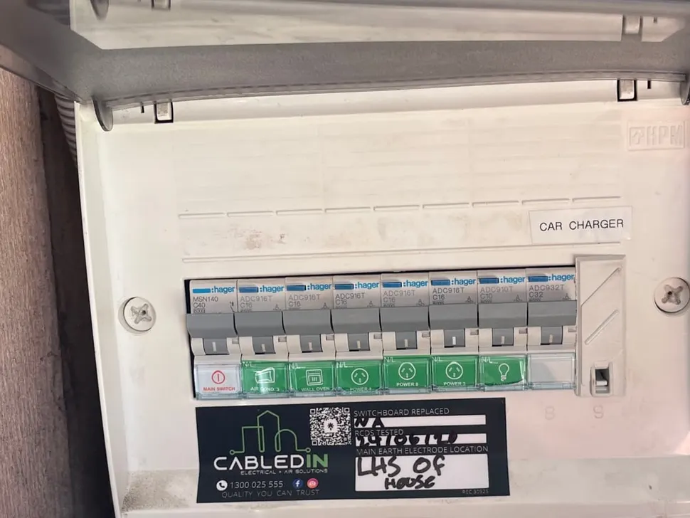 New switchboard with labelled circuits and the installer's compliance label fixed to the cover