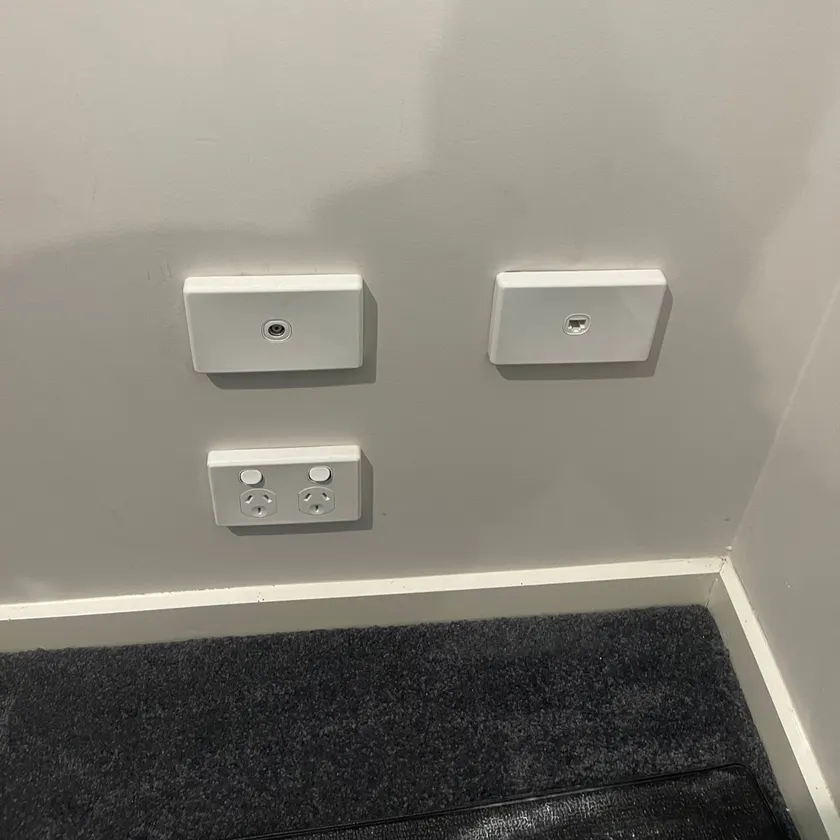 White data outlet, TV antenna outlet and double power point on a painted wall