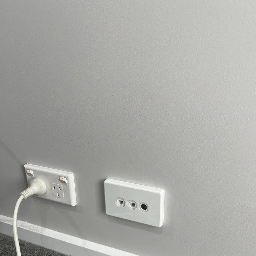 White wall plate with two data outlets and a TV outlet beside a double power point