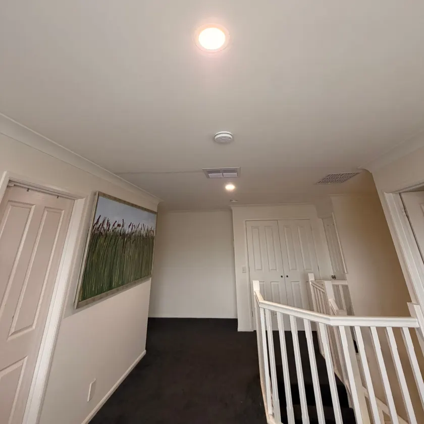 LED downlights switched on in the ceiling above a stair landing