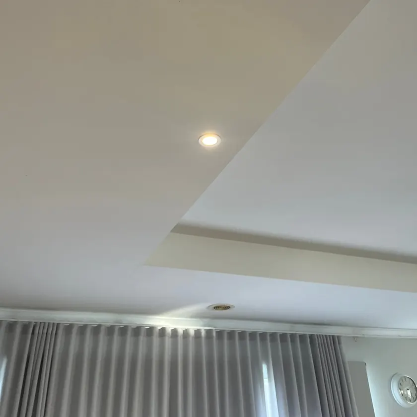 Single LED downlight set into a white bulkhead ceiling