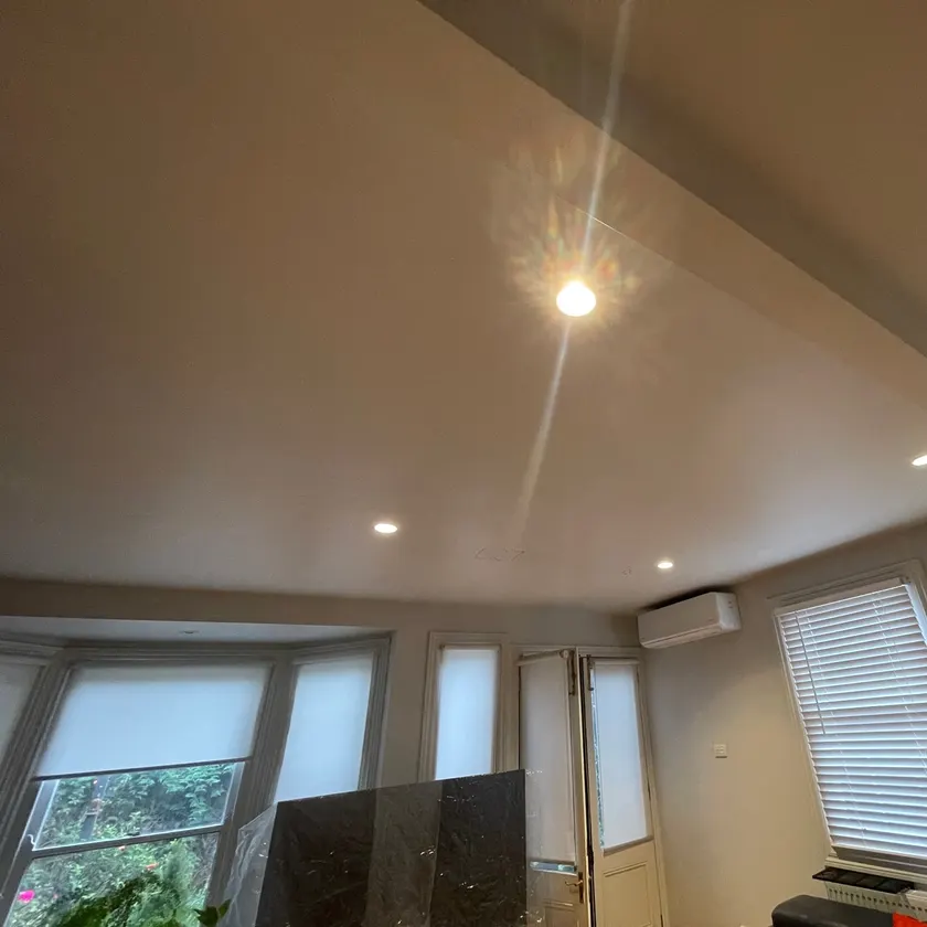 Several LED downlights switched on across a living room ceiling
