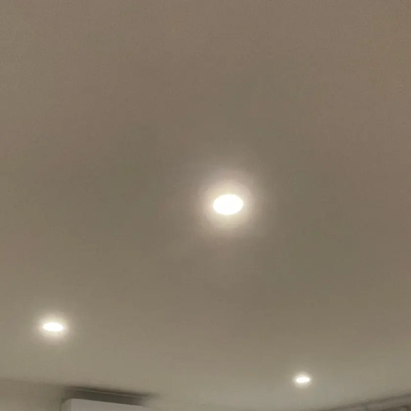 Four downlights in a lounge ceiling