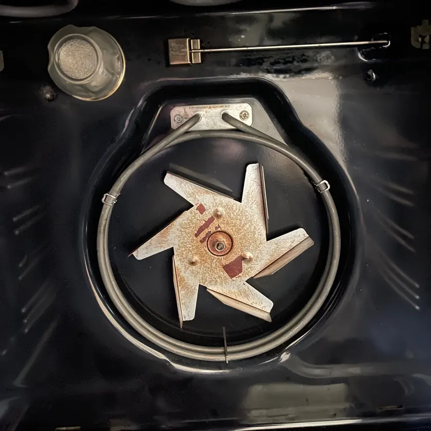 Oven fan and heating element exposed for repair