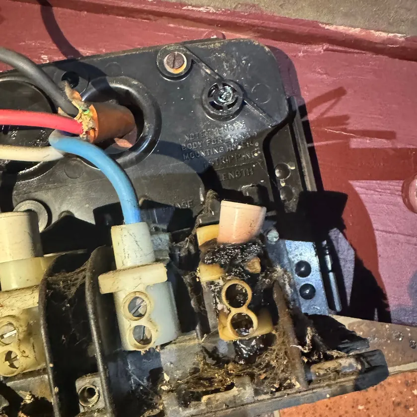 Close-up of a burnt terminal on an old fuse unit