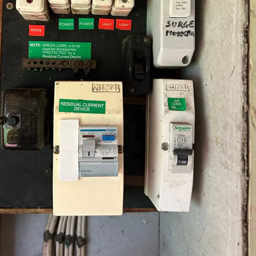 Old ceramic-fuse board with a new safety switch beside it