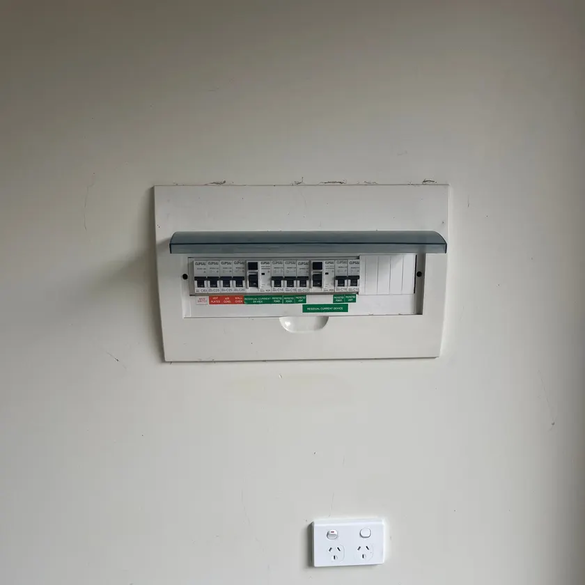 switchboard set in a wall beside a double power point, cover closed