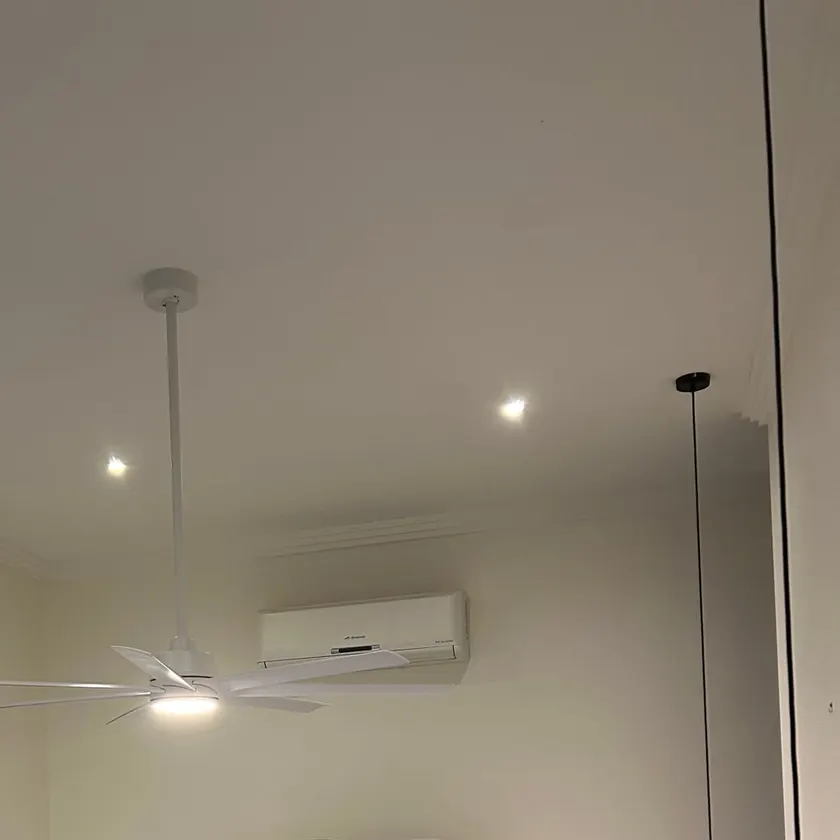 White ceiling fan with a central light on a white ceiling