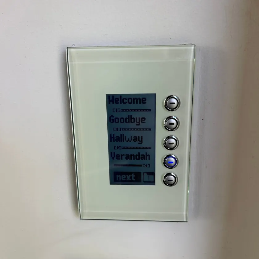 Glass lighting control panel on a wall with scene buttons