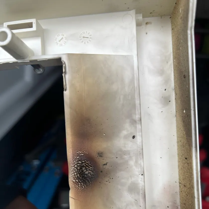Scorched and melted plastic on the inside of a switchboard enclosure