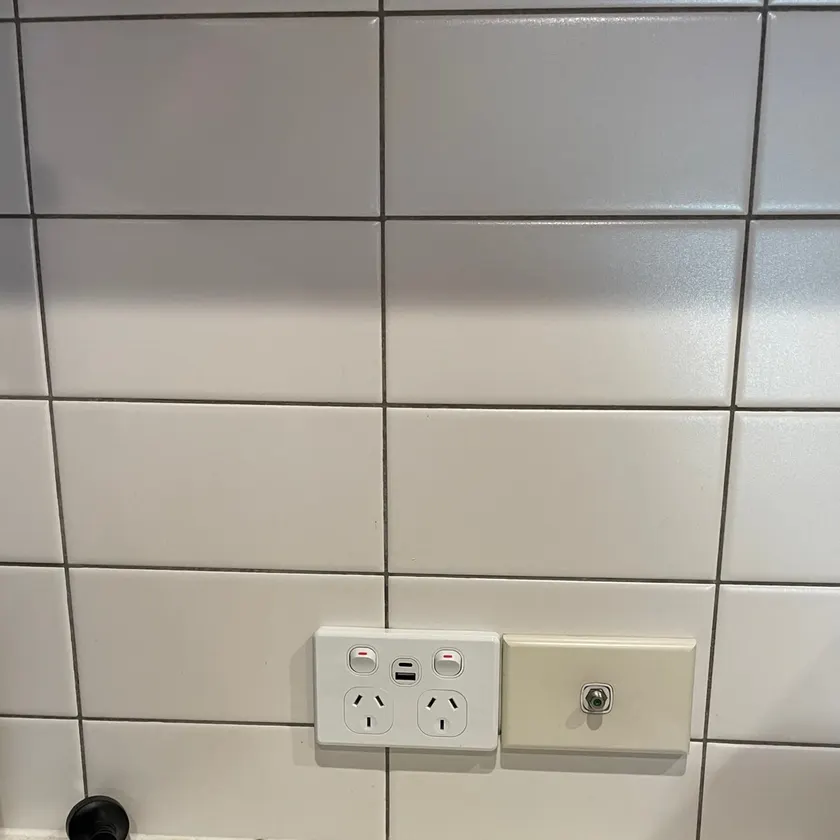 Double power point with USB-A and USB-C charging ports on a white subway-tile kitchen splashback