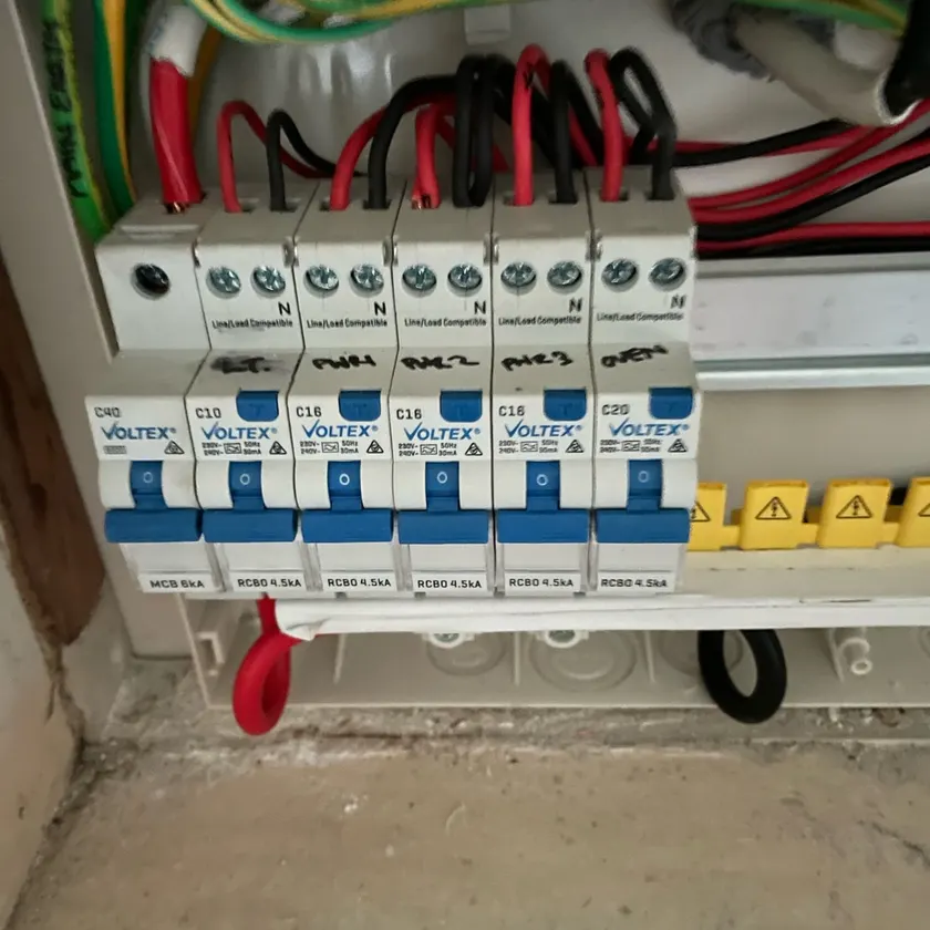 Five combined safety switches and a main switch being wired into a new switchboard, cover off