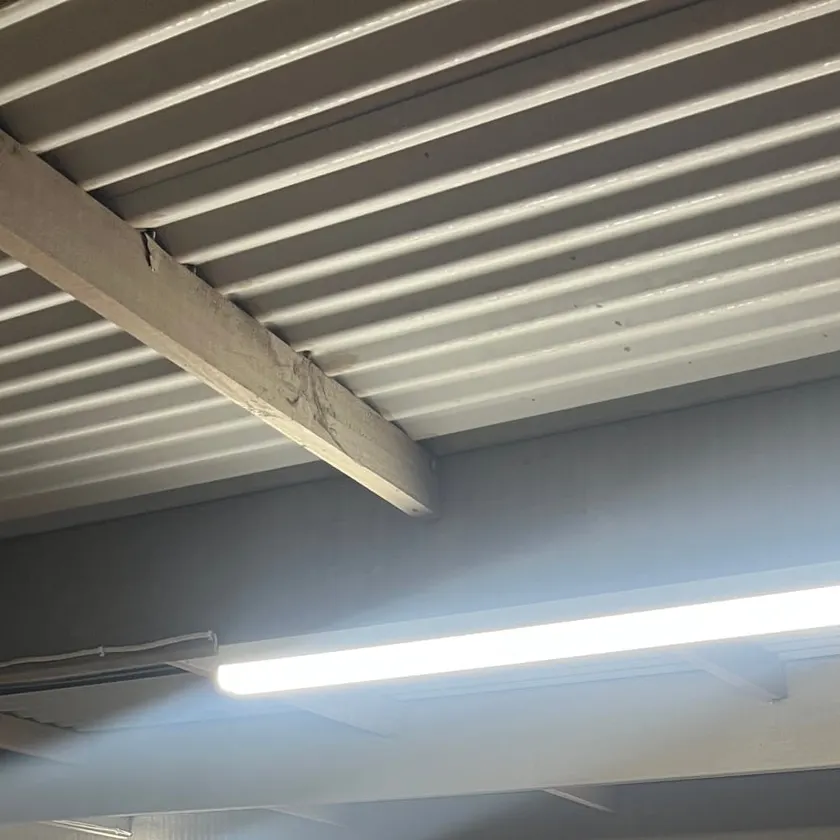 Garage ceiling with LED battens under a metal roof