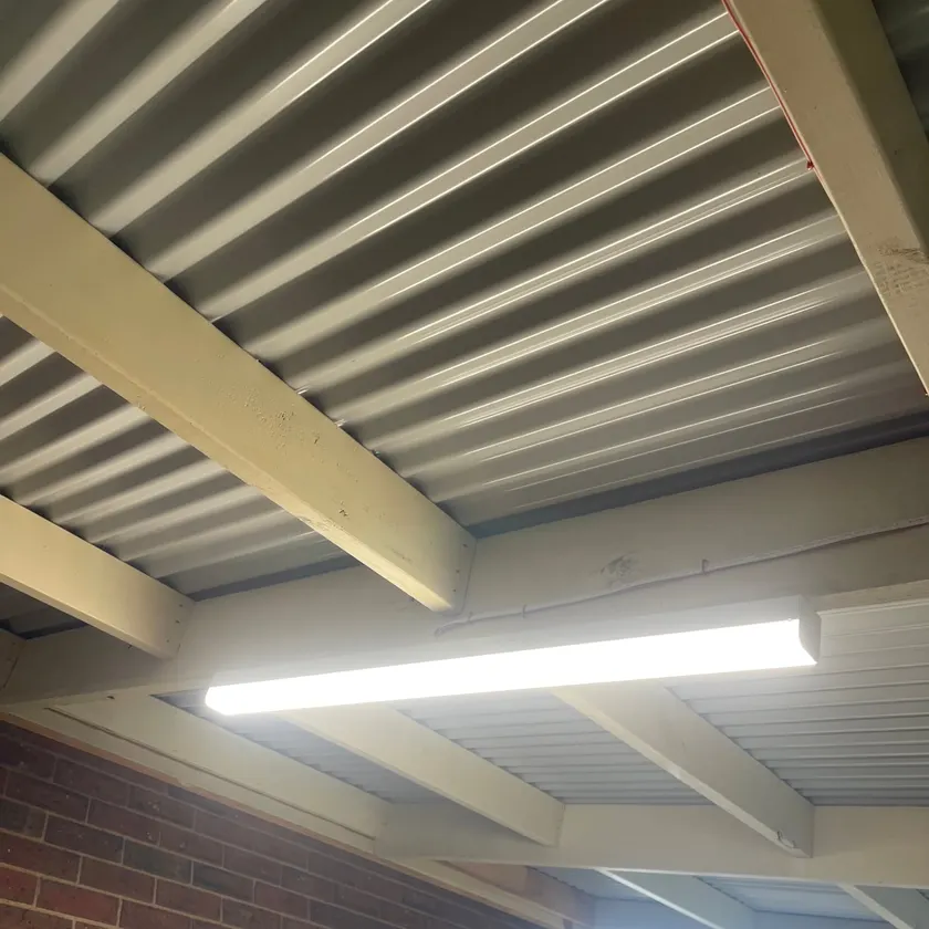 LED batten on a carport ceiling against a brick wall