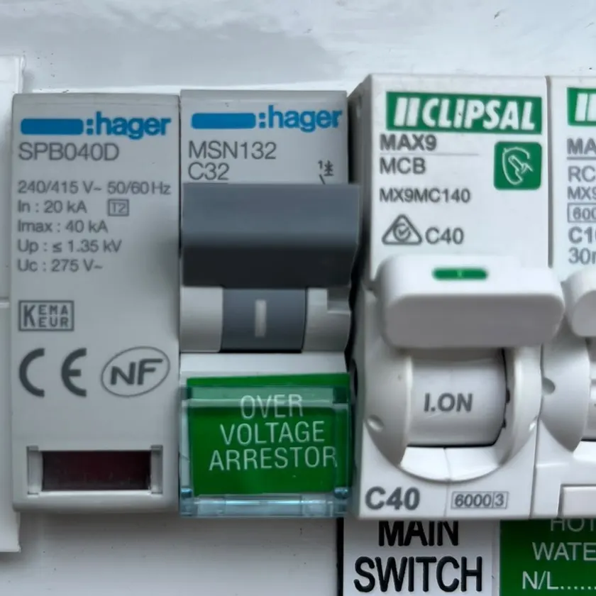 Type 2 surge protection device in a home switchboard, beside a breaker labelled over voltage arrestor and the main switch