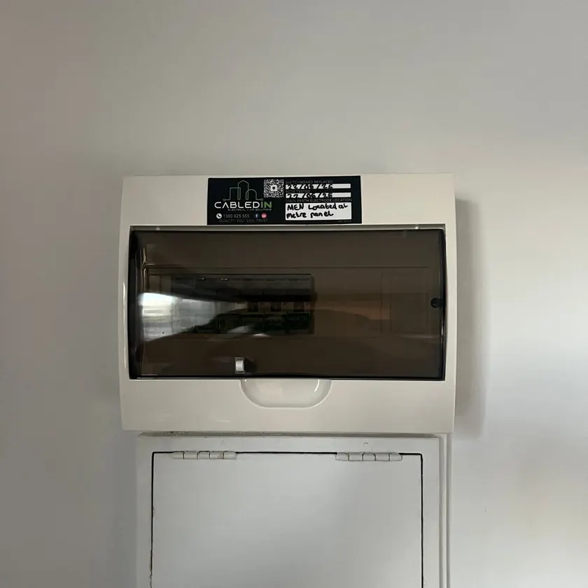 New switchboard with its cover closed, mounted on an interior wall